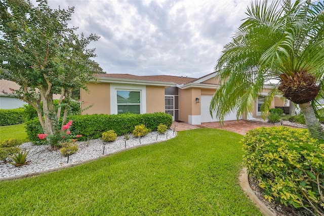 single story home featuring a front yard and stucco siding