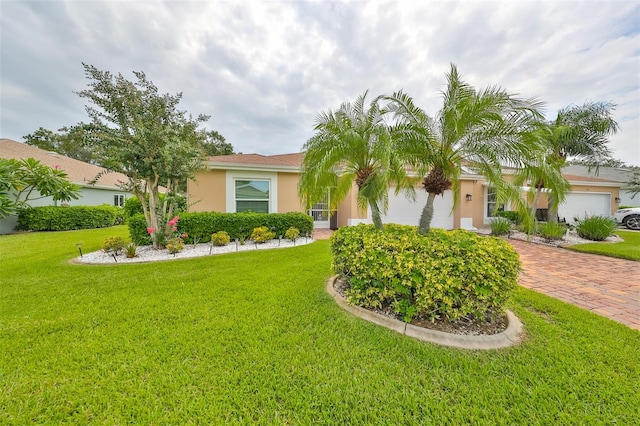 view of front of home with a garage and a front lawn