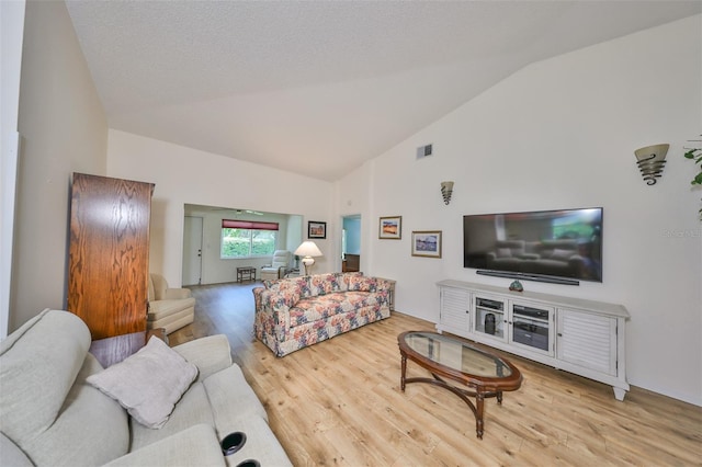 living room with high vaulted ceiling and wood-type flooring