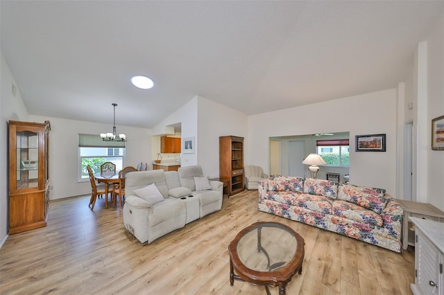 living room featuring light hardwood / wood-style floors, a notable chandelier, and plenty of natural light