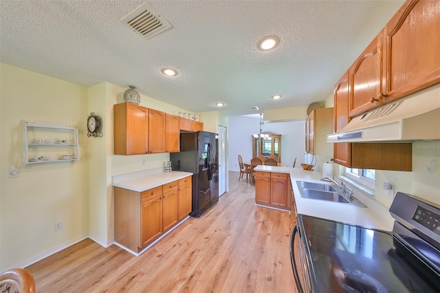 kitchen featuring light wood-type flooring, electric range, black fridge with ice dispenser, sink, and a textured ceiling