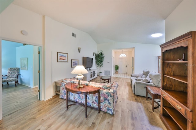 living room featuring light wood-type flooring and lofted ceiling