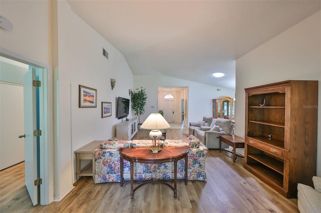 sitting room with lofted ceiling and hardwood / wood-style floors