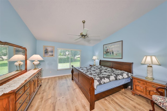 bedroom featuring light wood-type flooring, ceiling fan, and lofted ceiling