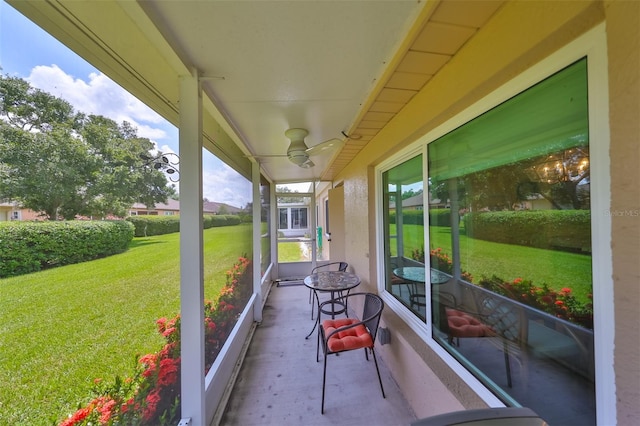 unfurnished sunroom with ceiling fan