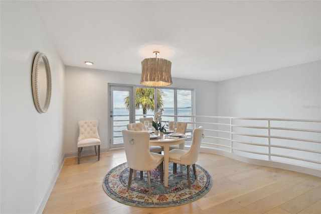 dining space with light wood finished floors and baseboards