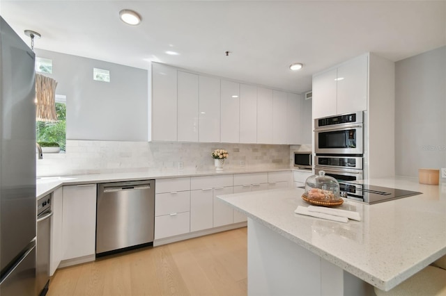 kitchen with white cabinetry, modern cabinets, and stainless steel appliances