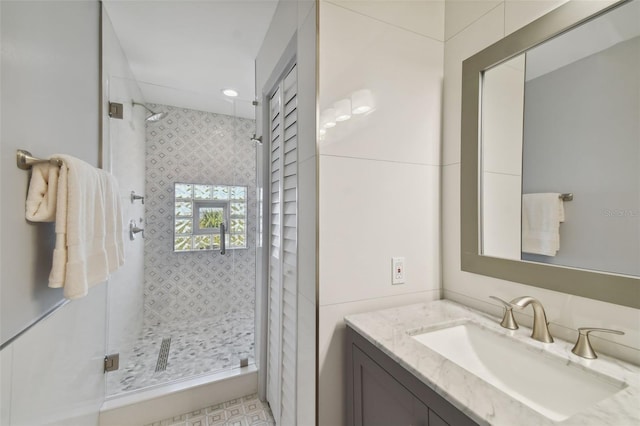 bathroom featuring a stall shower and vanity