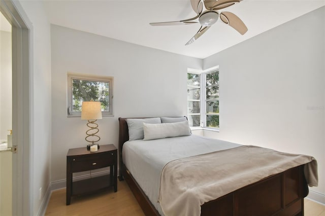 bedroom with ceiling fan, light hardwood / wood-style floors, and billiards