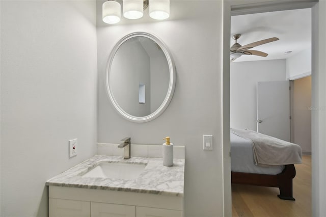 bathroom featuring wood finished floors, ceiling fan, and vanity