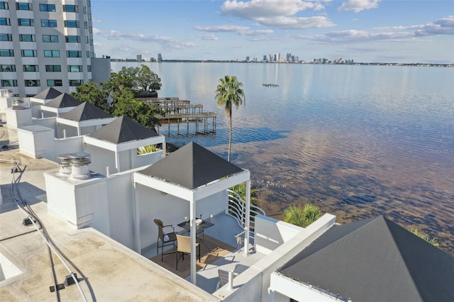 birds eye view of property with a water view and a city view