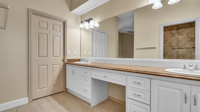 bathroom featuring tile patterned floors, ceiling fan, and vanity