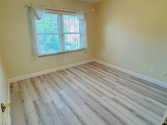 spare room with light hardwood / wood-style floors