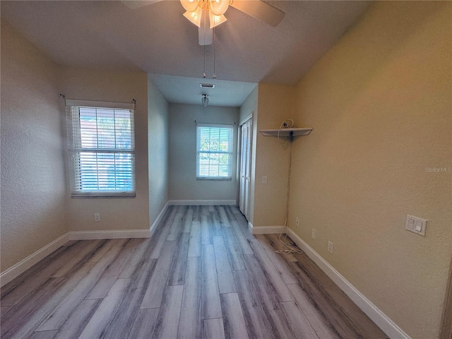 empty room featuring ceiling fan and light hardwood / wood-style flooring