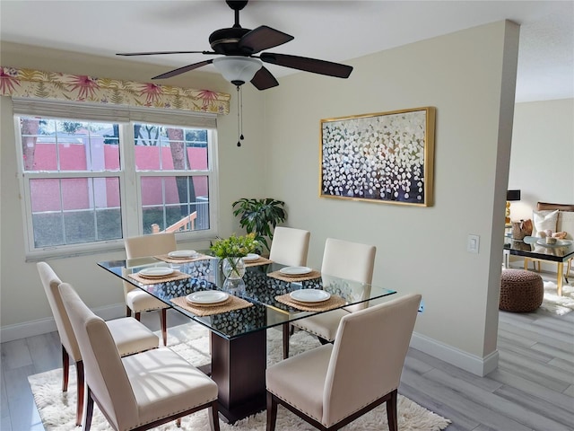 dining space with ceiling fan and light hardwood / wood-style flooring