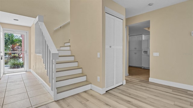 stairway with hardwood / wood-style floors