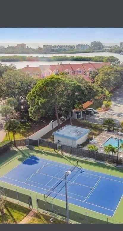 view of tennis court featuring fence