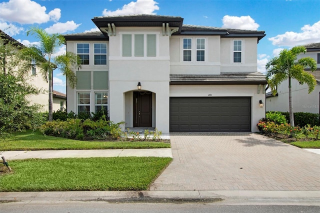 view of front of house with a garage and a front lawn