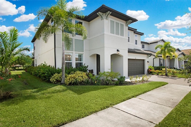 view of front of house with a front yard and a garage