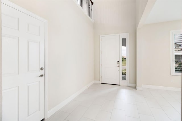 tiled entrance foyer featuring a high ceiling