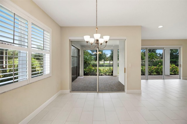 entryway with a wealth of natural light and a chandelier