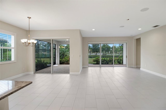 unfurnished room with a chandelier