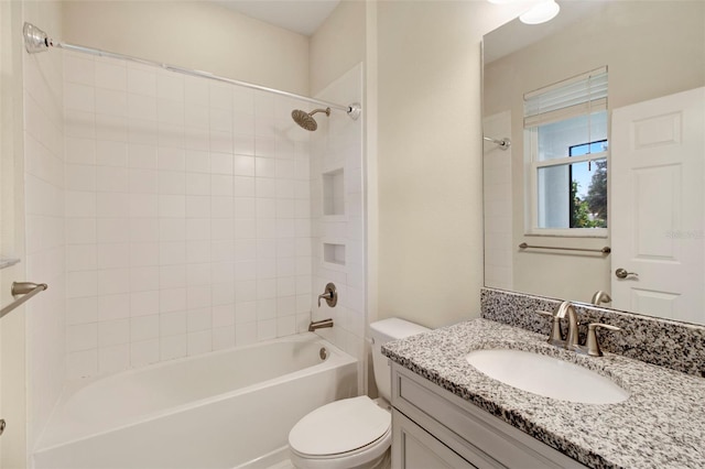 full bathroom featuring vanity, toilet, and tiled shower / bath