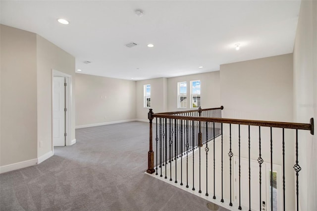 hallway with carpet floors