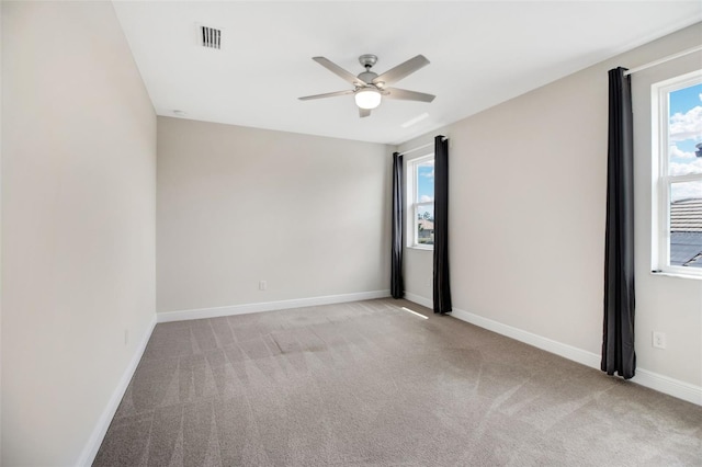 spare room with light carpet and ceiling fan