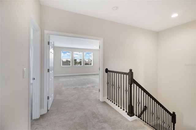 hallway featuring light colored carpet