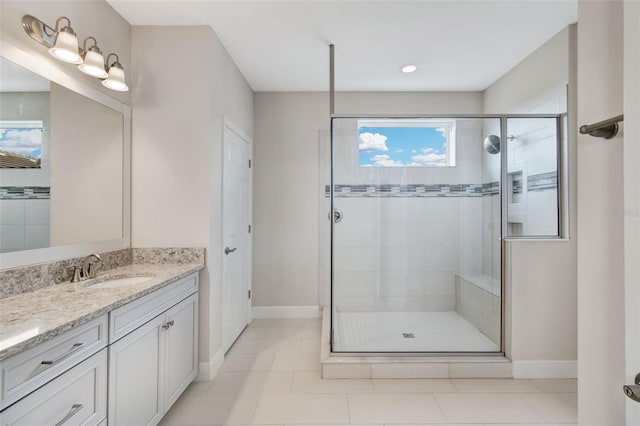 bathroom featuring tile patterned floors, vanity, and a shower with shower door