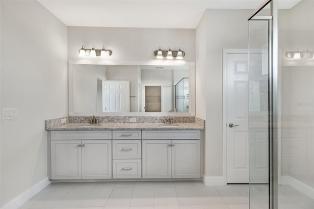 bathroom featuring tile patterned flooring, vanity, and walk in shower