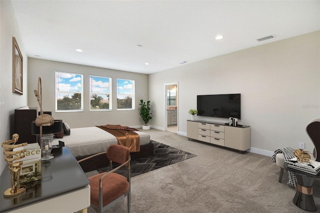 carpeted bedroom featuring connected bathroom