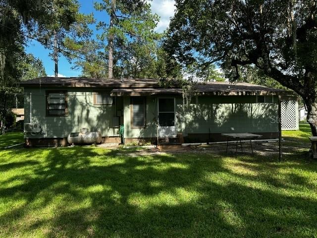 back of property with a lawn