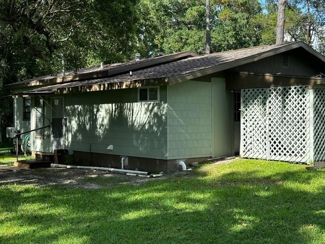 view of property exterior with a lawn