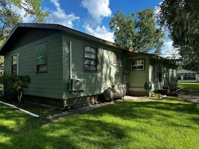 view of side of home featuring a lawn