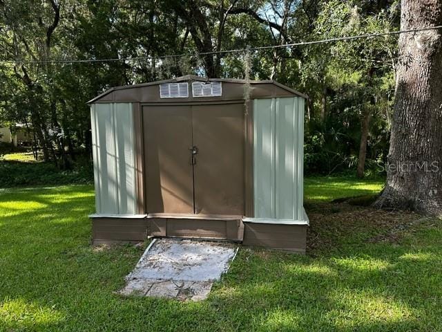 view of outdoor structure with a lawn