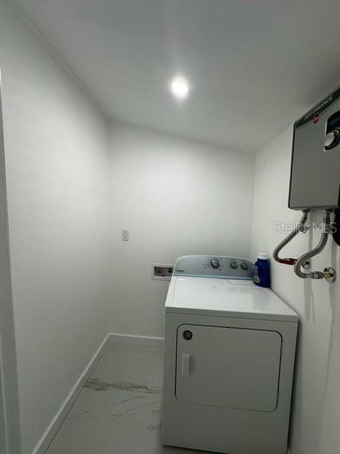 laundry room featuring tile patterned floors and washer / dryer