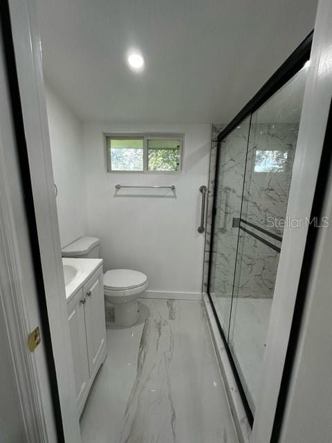 bathroom with a shower with door, toilet, vanity, and tile patterned floors