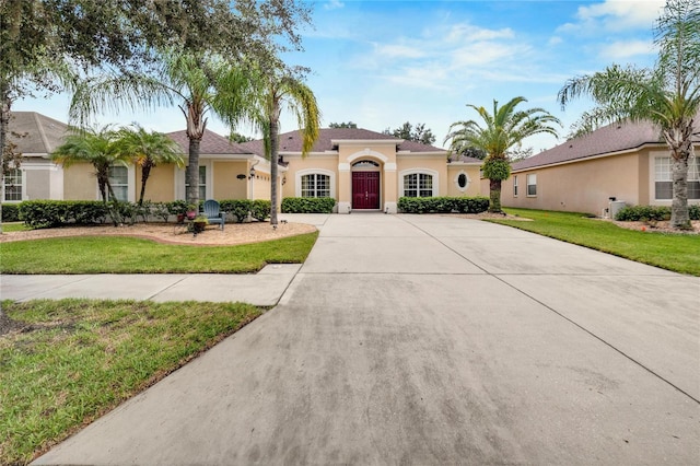 mediterranean / spanish house with a front yard