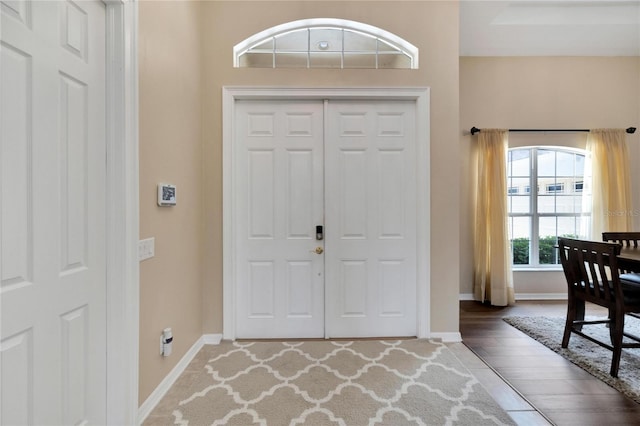 entryway with hardwood / wood-style floors