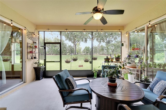 sunroom / solarium featuring ceiling fan