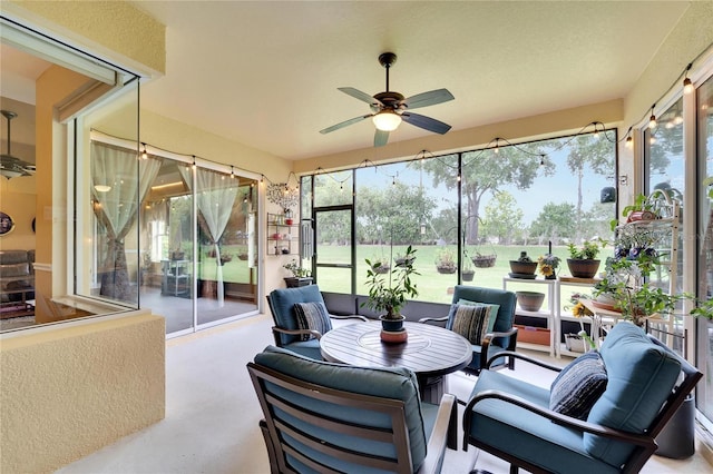 sunroom / solarium featuring ceiling fan