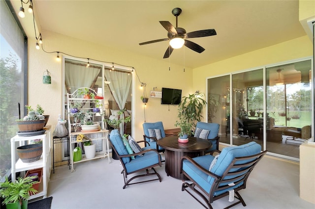 sunroom with plenty of natural light and ceiling fan