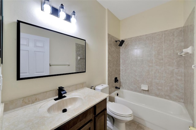 full bathroom featuring tiled shower / bath, vanity, toilet, and tile patterned flooring