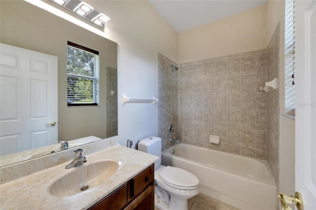 full bathroom featuring tiled shower / bath, vanity, toilet, and tile patterned flooring