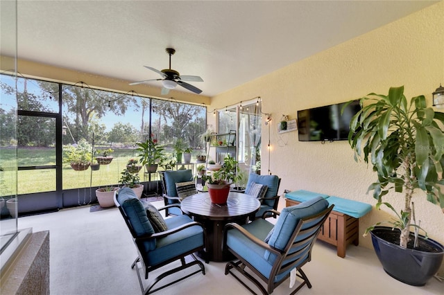 sunroom with a healthy amount of sunlight and ceiling fan