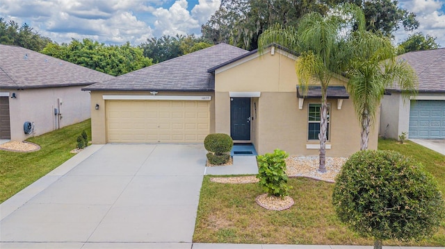 single story home featuring a garage and a front lawn