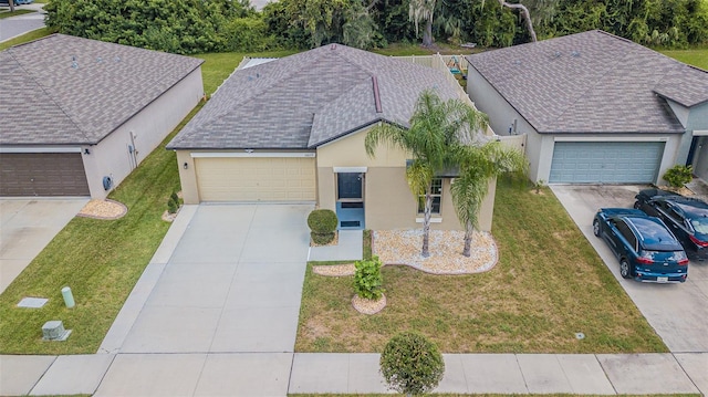 view of front of house with a garage and a front lawn