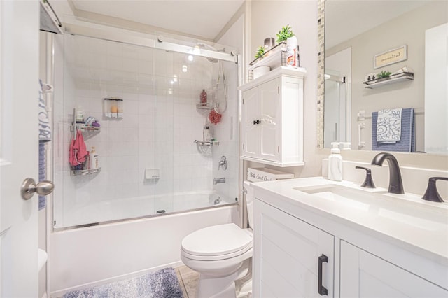 full bathroom featuring shower / bath combination with glass door, toilet, and vanity